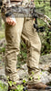 Pnuma Outdoors Pathfinder Pants in Dark Tan color, featuring durable 4-way stretch nylon fabric, articulated knees for enhanced mobility, moisture-wicking and quick-drying properties, and a versatile design suitable for both rugged outdoor adventures and everyday wear